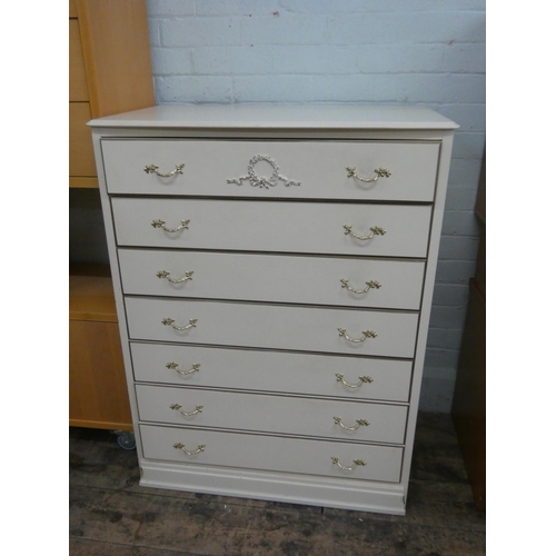 17 - A light cream and gilt decorated chest of seven long drawers, 31