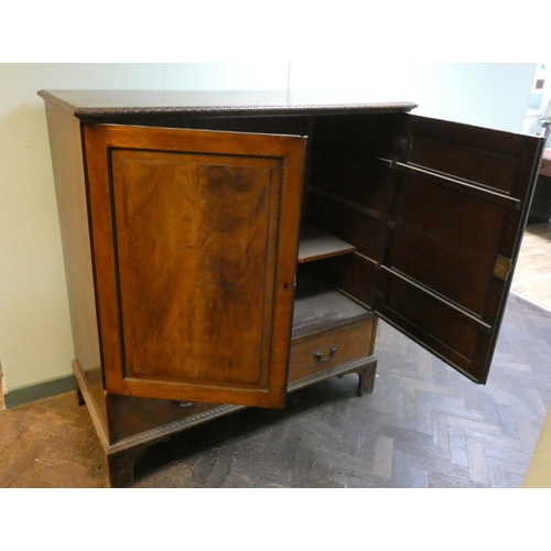 40 - A Georgian flame mahogany linen press style cabinet fitted one drawer to base (has been used as a TV...