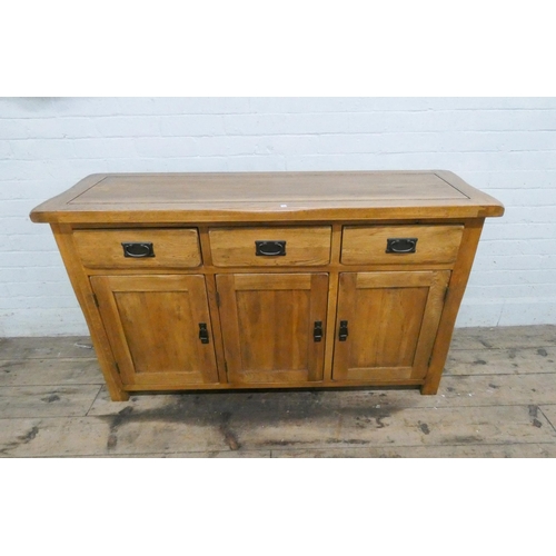 1 - A good quality light oak sideboard, fitted three drawers and cupboards. 55