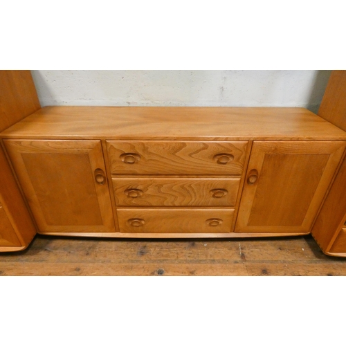 126 - A low Ercol Blonde Elm Windsor sideboard fitted three centre drawers and cupboards. 5' wide, 2'3