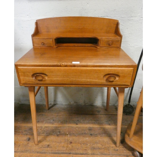 128 - An Ercol Windsor Blonde Elm ladies writing desk with low back, fitted two drawers and one long drawe... 