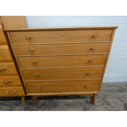 26 - An Alfred Cox pale teak chest of five long drawers. 34