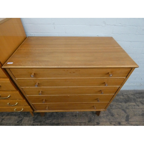 26 - An Alfred Cox pale teak chest of five long drawers. 34