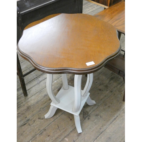 64 - A shaped circular mahogany occasional table on cream painted base