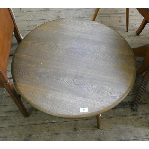 67 - An Ercol circular oak coffee table. 2'6