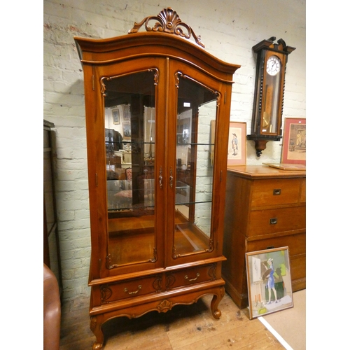 303 - A French style mahogany glazed china display cabinet with one glazed door, glass shelves and two dra... 