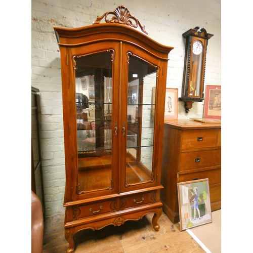 303 - A French style mahogany glazed china display cabinet with one glazed door, glass shelves and two dra... 