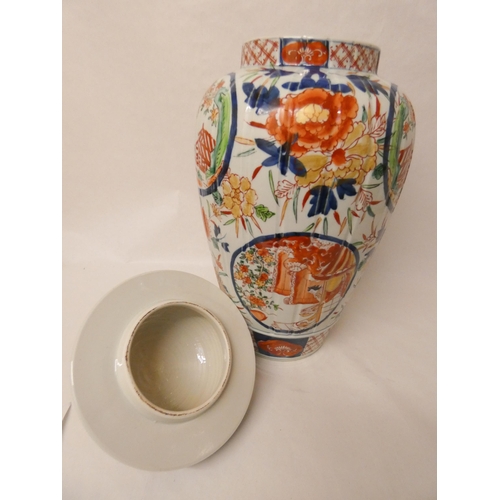 243 - A large Imari ginger jar and cover. 55cm tall