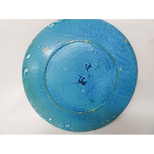 244 - A large Iznik circular charger plate decorated in turquoise and blue with swan border. 47cm diameter