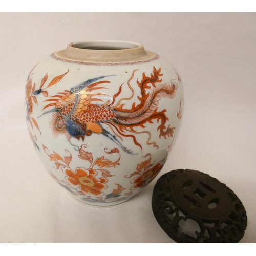 245 - An Imari ginger jar and cover with pierced hardwood lid, jar is 22 cms tall