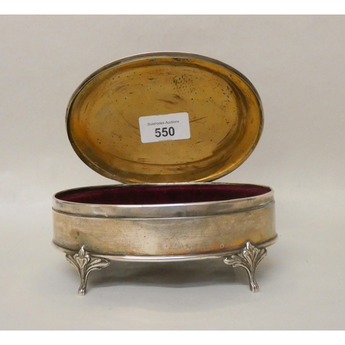 550 - A large oval hallmarked silver dressing table trinket box, the hinged lid with engine turned decorat... 