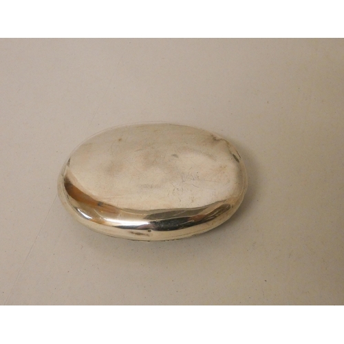 553 - A oval continental silver patch or snuff box, the hinged lid decorated with merry-making scene. Impo... 