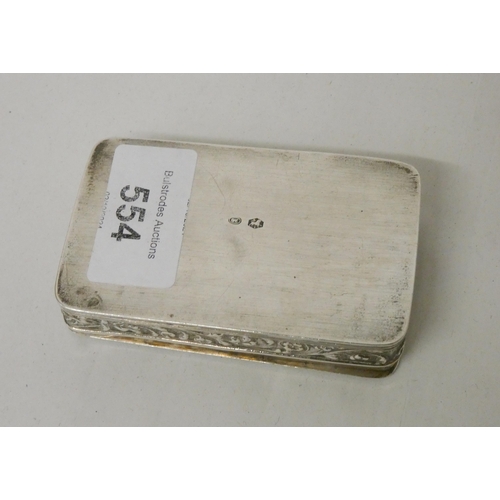 554 - A Dutch silver snuff box of rectangular form, the hinged lid embossed with village scene. Diameter 8... 