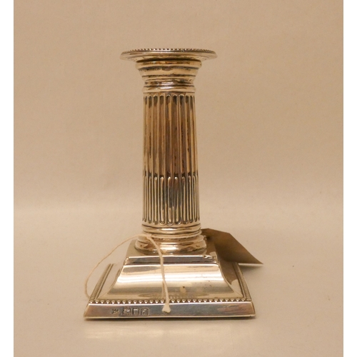 555 - A single squat silver column candlestick by the Goldsmiths and Silversmiths Company, London, 1900. W... 