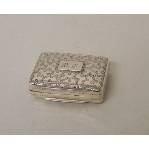 559 - An antique silver vinaigrette of rectangular form with floral engraving, gilded interior and grille.... 