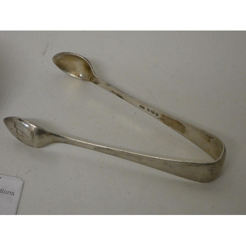 568 - A collection of Victorian and later silver spoons and a pair of sugar nips. 5.1 troy oz