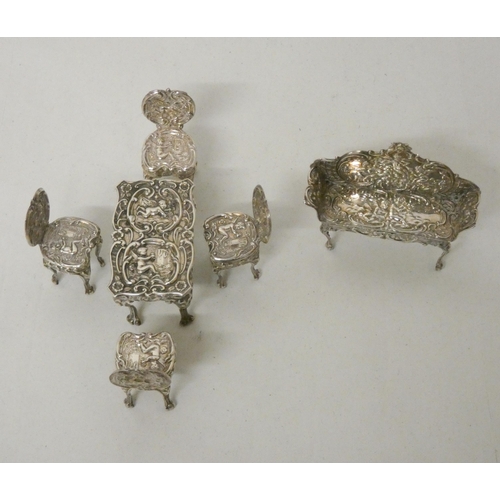 572 - An Edwardian hallmarked silver miniature novelty table and chair set.  Hallmarked Birmingham 1901. L... 