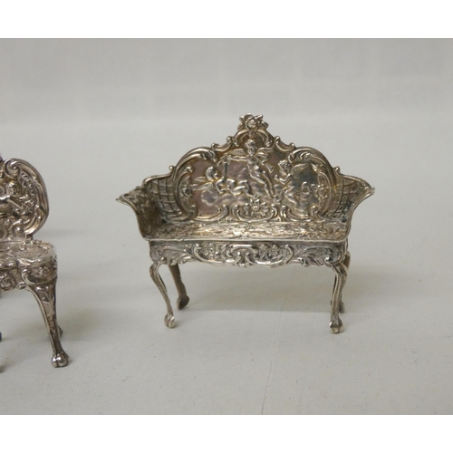 572 - An Edwardian hallmarked silver miniature novelty table and chair set.  Hallmarked Birmingham 1901. L... 