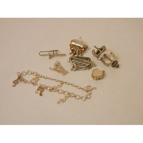 577 - A collection of miniature silver models of musical instruments. To include brooches etc