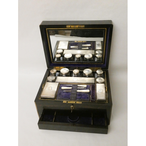 580 - A Victorian Coromandel fitted dressing table box containing ten silver topped bottles and boxes with... 