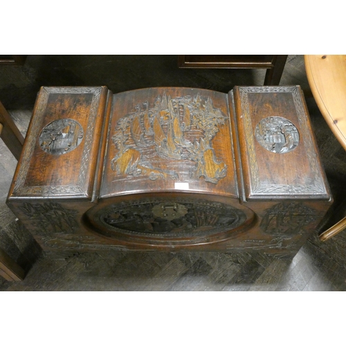 154 - A Chinese carved camphor wood blanket chest with recessed domed centre section. 3' wide