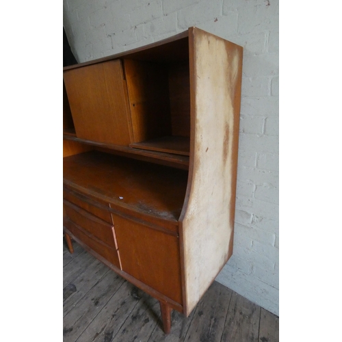 325 - A teak bow front high sideboard fitted shelves with drawers and cupboards under. 4'3