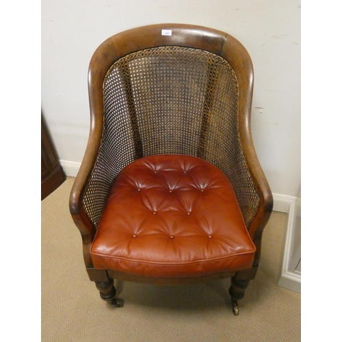 345 - A Victorian mahogany Bergere library chair with studded red leather cushions