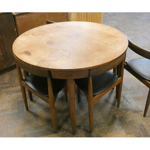 369 - A Danish Frem Rojle Roundette circular teak dining table with fold away centre leaf and six matching... 