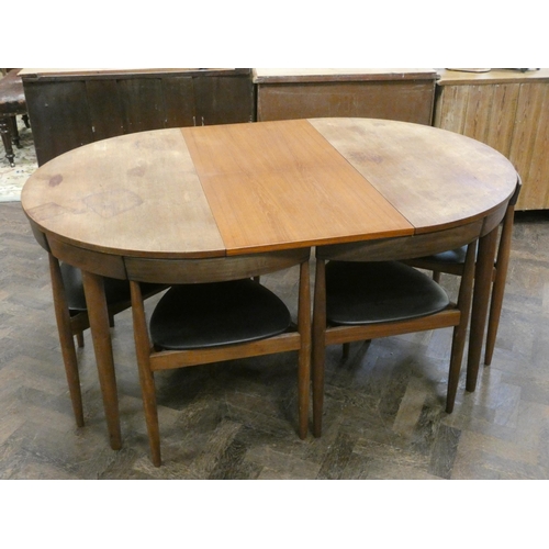 369 - A Danish Frem Rojle Roundette circular teak dining table with fold away centre leaf and six matching... 