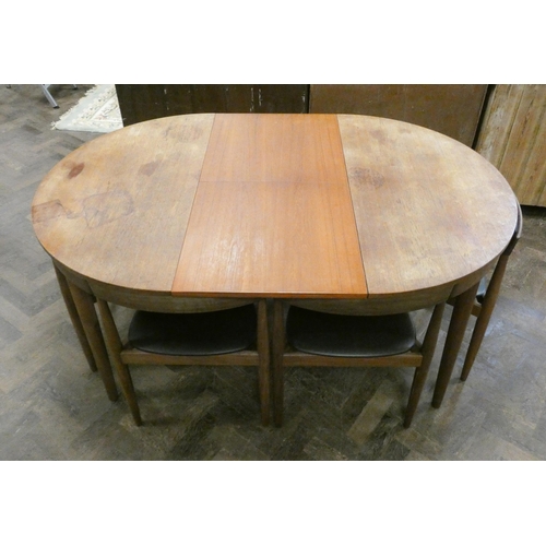 369 - A Danish Frem Rojle Roundette circular teak dining table with fold away centre leaf and six matching... 