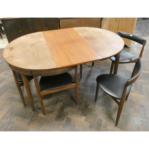 369 - A Danish Frem Rojle Roundette circular teak dining table with fold away centre leaf and six matching... 