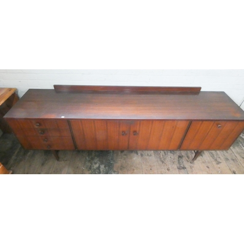 370 - A long low dark teak 1960's/1970's sideboard, fitted four drawers, centre cupboards and drop-down wi... 