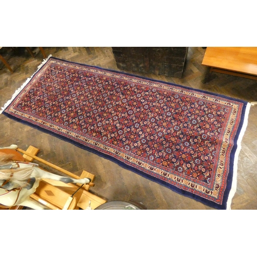 378 - A blue and patterned wool pile Persian style rug or runner 10'x4' approx