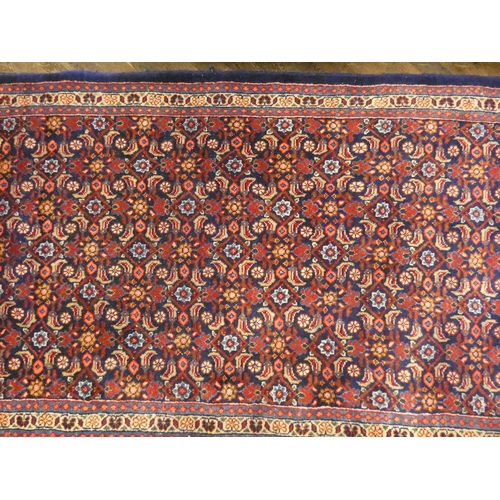 378 - A blue and patterned wool pile Persian style rug or runner 10'x4' approx