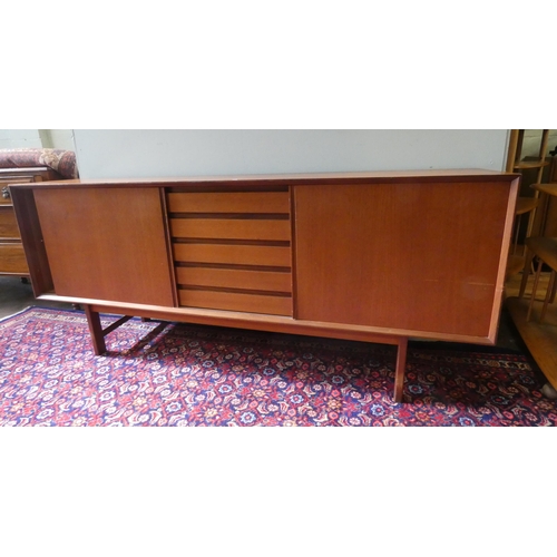 379 - A 1970's long low teak sideboard with sliding doors and five centre drawers 6'3