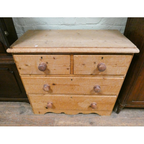 390 - A Victorian stripped pine chest of two long and two short drawers with bun handles. 35