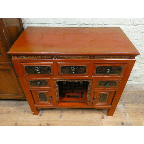 396 - A Chinese red and lacquered side cabinet fitted five drawers and cupboards with centre pigeon hole 3... 