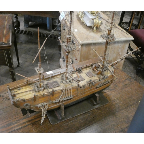 414 - A hand built model of Captain Cook's Endeavour wooden galleon on stand. Overall length 30