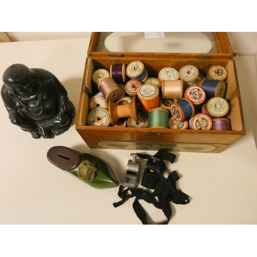 424 - A box of assorted cottons, two whistles, a Buddha etc