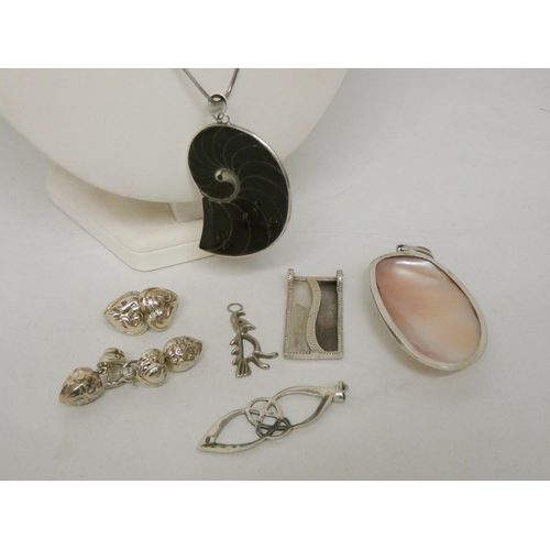 605 - A large silver shell pendant on chain together with two pairs of silver earrings and four silver pen... 