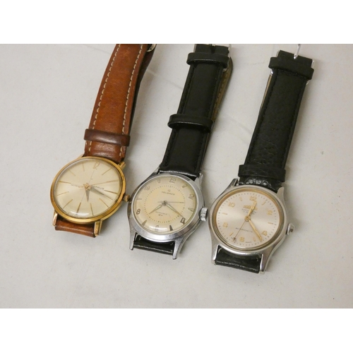 613 - A collection of three gents automatic wrist watches. By Roamer, Benrus and Helbros.