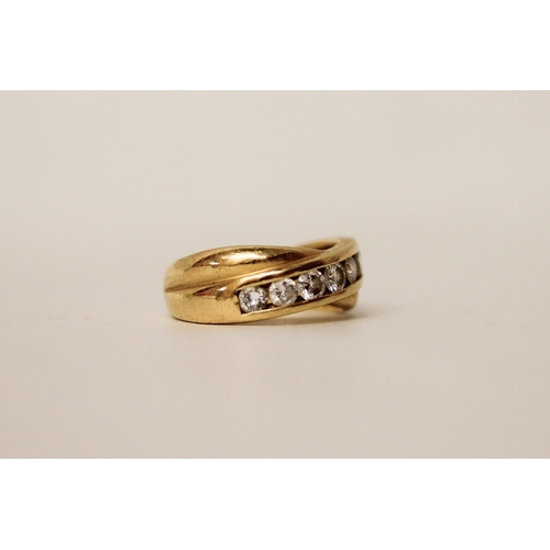 644 - An 18ct yellow gold diamond eternity ring in a crossover setting, hallmarked with diamond weight, ma... 