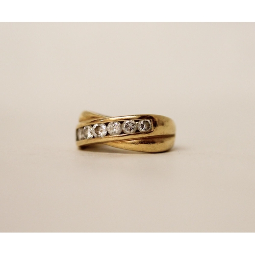 644 - An 18ct yellow gold diamond eternity ring in a crossover setting, hallmarked with diamond weight, ma... 