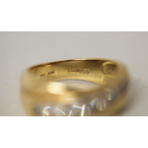 644 - An 18ct yellow gold diamond eternity ring in a crossover setting, hallmarked with diamond weight, ma... 