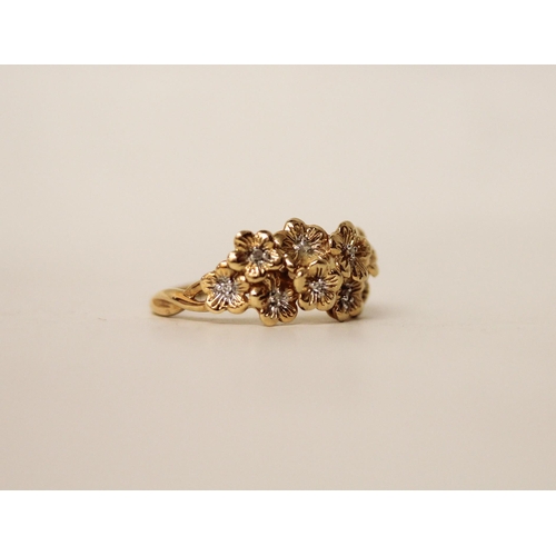 646 - A 14ct yellow gold and diamond flower cluster dress ring. Hallmarked. Ring size S. Gross weight 3.7g... 