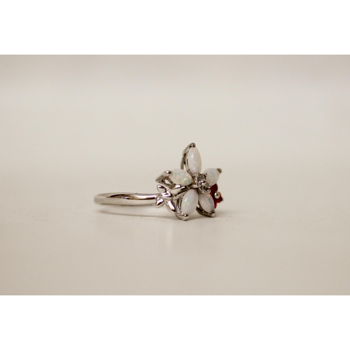 651 - A modern 9ct white gold opal cluster ring in a floral design. Ring size Q. Gross weight 2.8gms