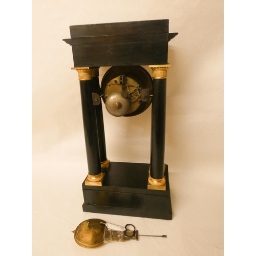 255 - A French empire striking mantel clock in an ebonised and gilt mounted case