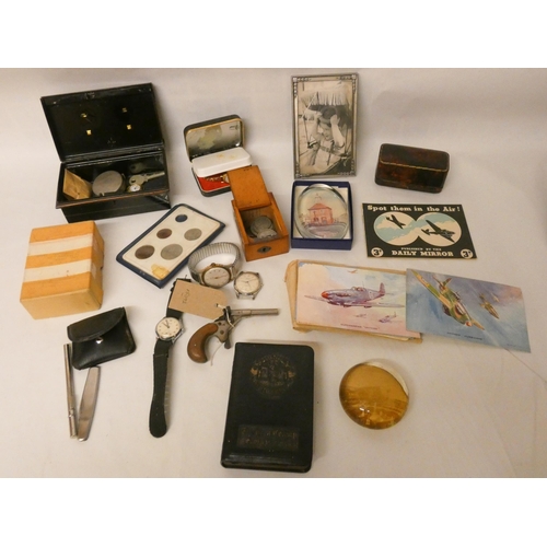 748 - Collectables to include cash tin, paperweights, wrist watches, postcards, coinage, a miniature pisto... 