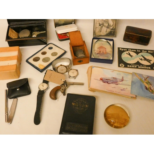 748 - Collectables to include cash tin, paperweights, wrist watches, postcards, coinage, a miniature pisto... 