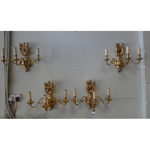 407 - Four heavy gilt brass cherub mounted three branch girandoles, possibly by Dernier & Hamlyn, mid cent... 